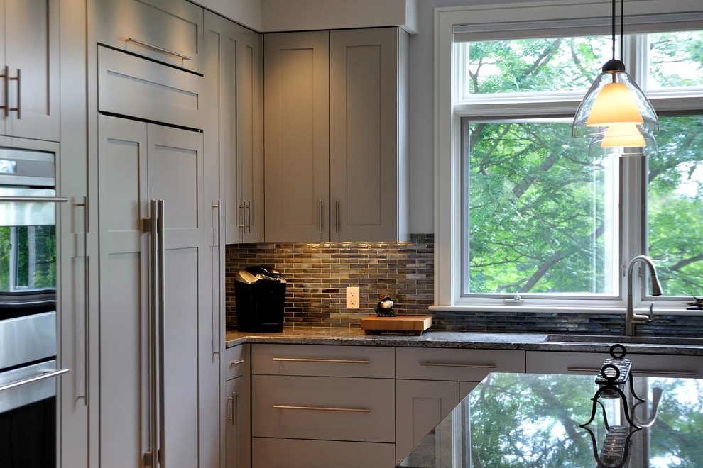 Design ideas for a classic kitchen in Burlington with recessed-panel cabinets, grey cabinets, granite worktops, stainless steel appliances and an island.