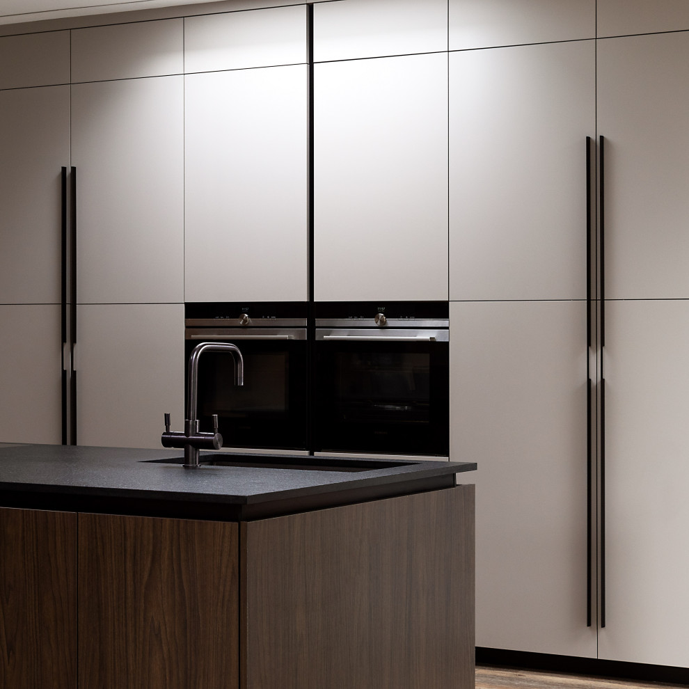 This is an example of a medium sized contemporary kitchen in West Midlands with granite worktops and an island.