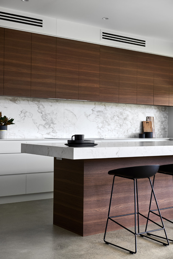 This is an example of a large contemporary kitchen in Sydney with a double-bowl sink, medium wood cabinets, marble worktops, white splashback, marble splashback, concrete flooring and an island.