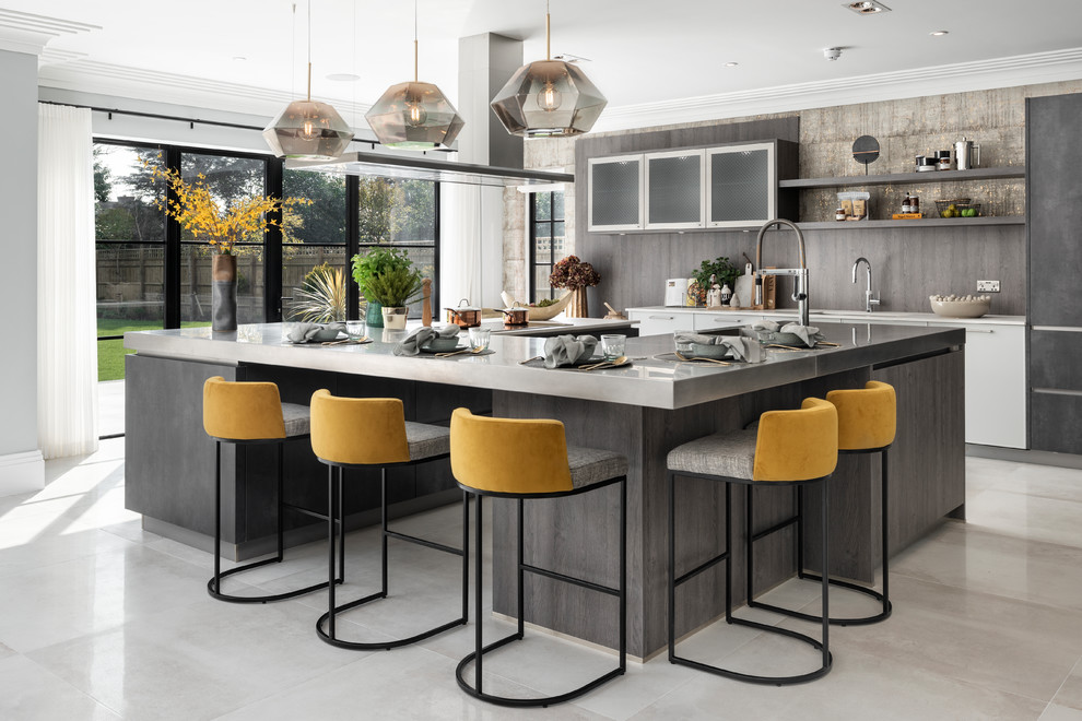 Kitchen - large contemporary gray floor kitchen idea in Buckinghamshire with an island, glass-front cabinets, brown backsplash, wood backsplash and white countertops