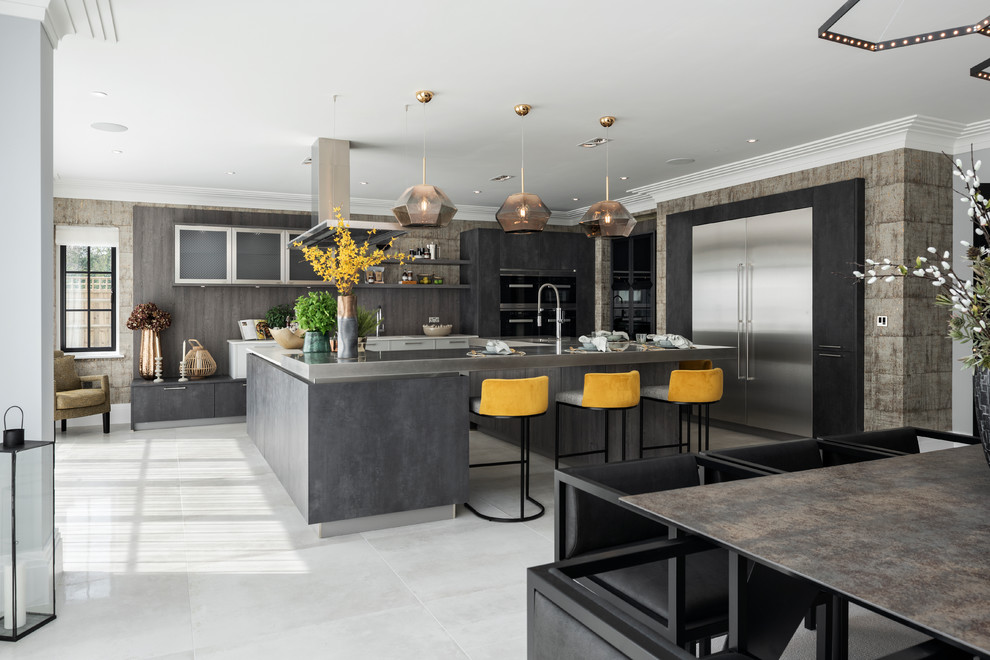 Large contemporary u-shaped open plan kitchen in Buckinghamshire with flat-panel cabinets, grey cabinets and an island.