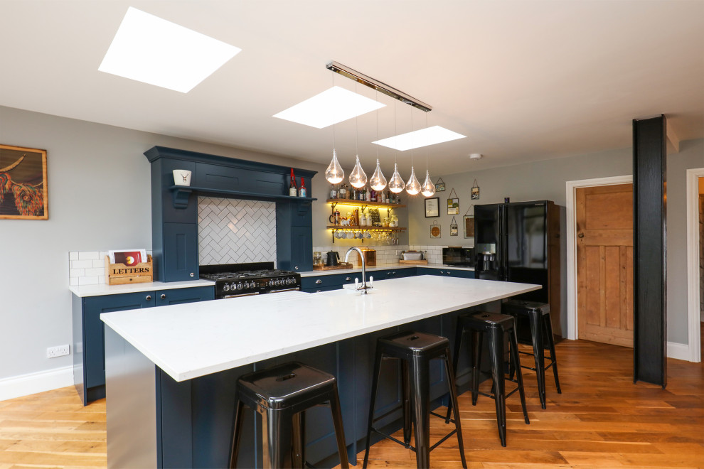 Immagine di una cucina chic di medie dimensioni con ante in stile shaker, ante blu, top in laminato, paraspruzzi bianco e top bianco
