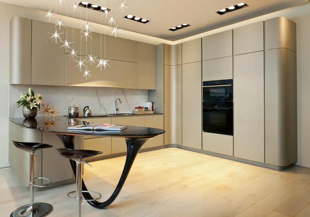 Design ideas for a modern l-shaped kitchen in DC Metro with flat-panel cabinets, glass worktops, white splashback, light hardwood flooring, a submerged sink, stone slab splashback and integrated appliances.
