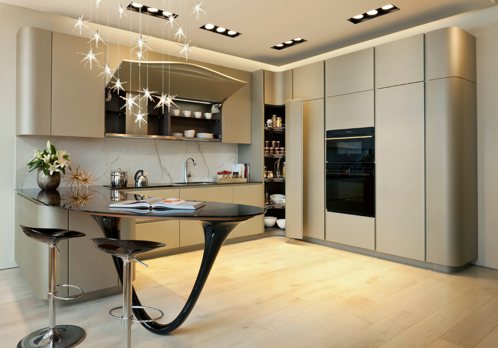 This is an example of a modern l-shaped kitchen in DC Metro with flat-panel cabinets, glass worktops, white splashback, light hardwood flooring, a submerged sink, stone slab splashback and integrated appliances.
