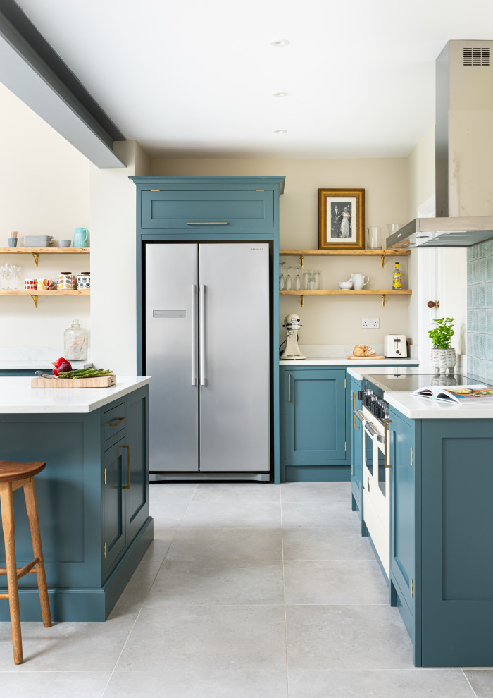 Example of a mid-sized classic l-shaped eat-in kitchen design in London with shaker cabinets, blue cabinets, quartzite countertops, an island and white countertops