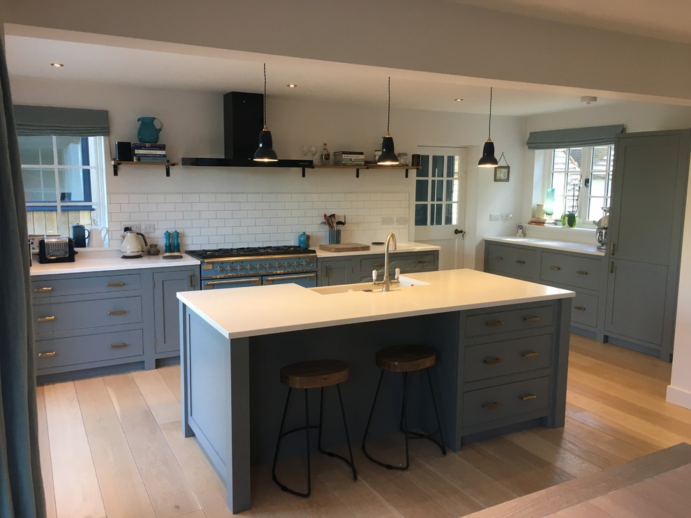 Stunning blue kitchen with island and builtin breakfast bar Modern