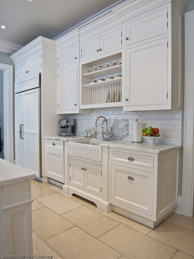 Large transitional u-shaped limestone floor and beige floor open concept kitchen photo in Toronto with a farmhouse sink, shaker cabinets, white cabinets, marble countertops, white backsplash, subway tile backsplash, stainless steel appliances and an island