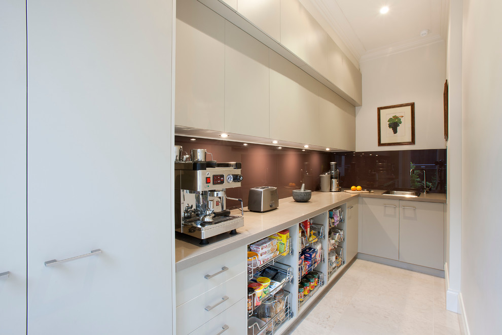 Photo of a large contemporary kitchen pantry in Melbourne with a submerged sink, flat-panel cabinets, medium wood cabinets, granite worktops, red splashback, glass sheet splashback, stainless steel appliances, porcelain flooring and an island.