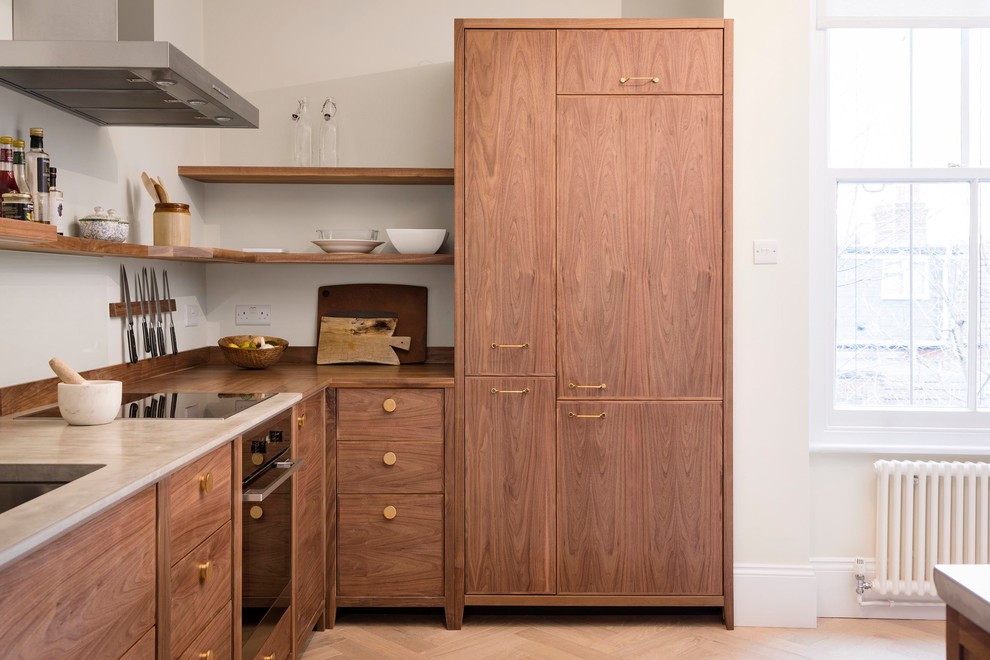 Example of a small minimalist l-shaped light wood floor and beige floor eat-in kitchen design in London with a drop-in sink, flat-panel cabinets, dark wood cabinets, concrete countertops, gray backsplash, glass sheet backsplash, stainless steel appliances, no island and gray countertops
