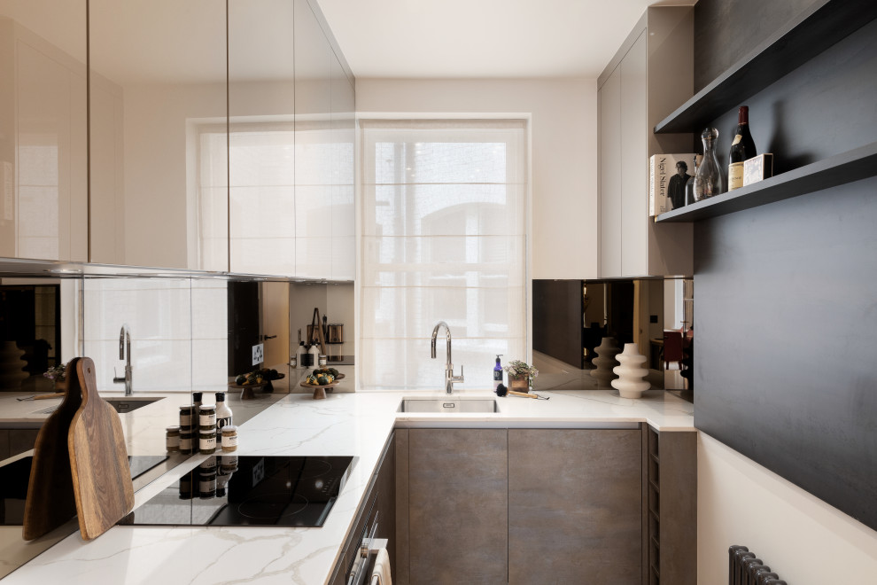 Inspiration for a small contemporary u-shaped enclosed kitchen in London with a submerged sink, flat-panel cabinets, beige cabinets, quartz worktops, mirror splashback, black appliances, medium hardwood flooring, no island, beige floors, white worktops and a coffered ceiling.