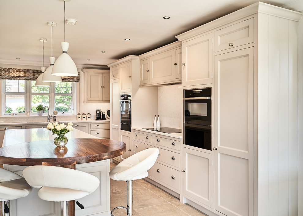 Design ideas for a medium sized traditional kitchen in Other with recessed-panel cabinets, white cabinets, quartz worktops, an island, white worktops, white splashback, mosaic tiled splashback, black appliances and brown floors.