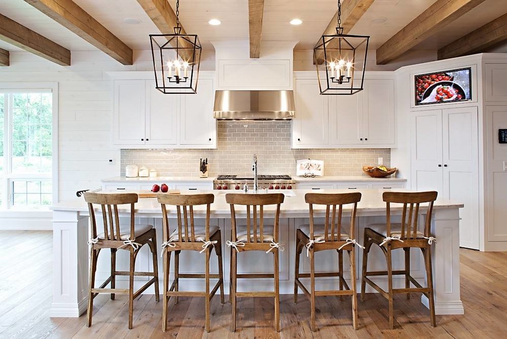 Mid-sized mountain style galley light wood floor eat-in kitchen photo in Other with a double-bowl sink, flat-panel cabinets, white cabinets, laminate countertops, gray backsplash, ceramic backsplash, stainless steel appliances and an island