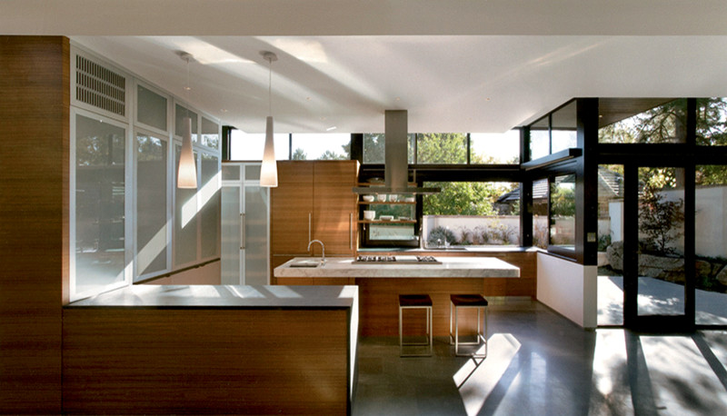 Example of a large trendy u-shaped gray floor enclosed kitchen design in Portland with flat-panel cabinets and an island