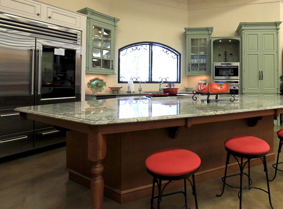 Photo of a traditional u-shaped kitchen/diner in Austin with a submerged sink and green cabinets.
