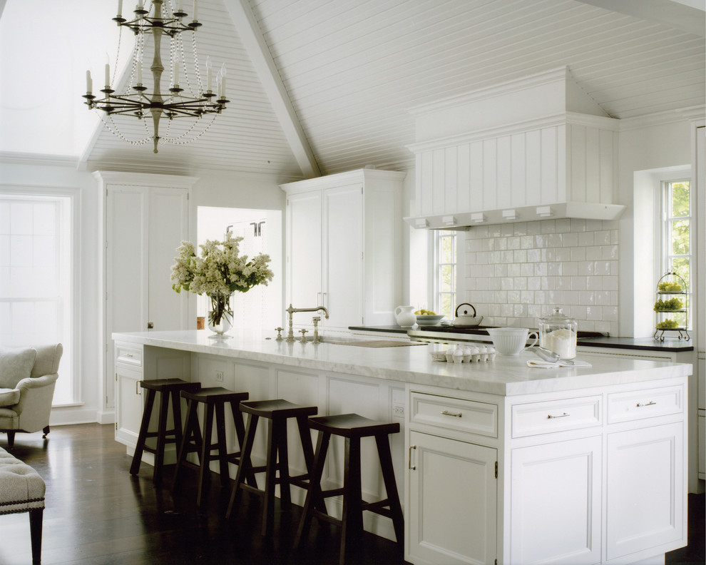 Ejemplo de cocina comedor tradicional con puertas de armario blancas, salpicadero blanco y suelo de madera en tonos medios