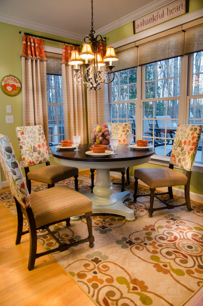 This is an example of a shabby-chic style dining room in Raleigh.