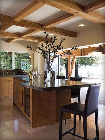 Example of a large trendy u-shaped limestone floor eat-in kitchen design in San Francisco with flat-panel cabinets, light wood cabinets, laminate countertops, stainless steel appliances, two islands, an undermount sink and multicolored backsplash