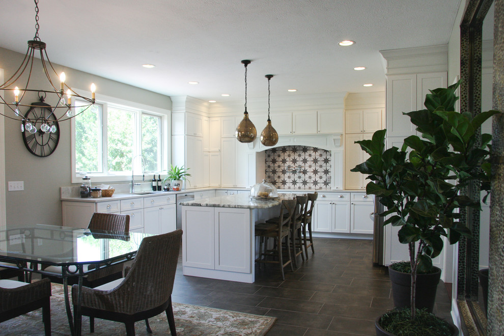 Example of a mid-sized classic u-shaped porcelain tile and brown floor eat-in kitchen design in Cleveland with an undermount sink, shaker cabinets, white cabinets, quartz countertops, beige backsplash, ceramic backsplash, stainless steel appliances and an island