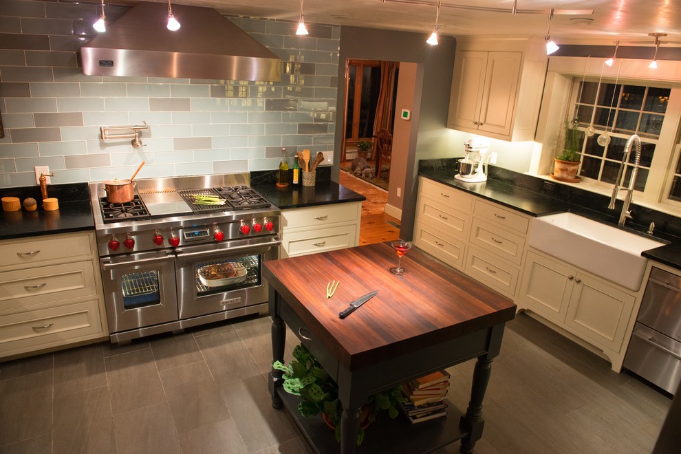 Example of a mid-sized classic u-shaped ceramic tile eat-in kitchen design in Boston with a farmhouse sink, beaded inset cabinets, white cabinets, blue backsplash, stainless steel appliances, soapstone countertops, subway tile backsplash and two islands