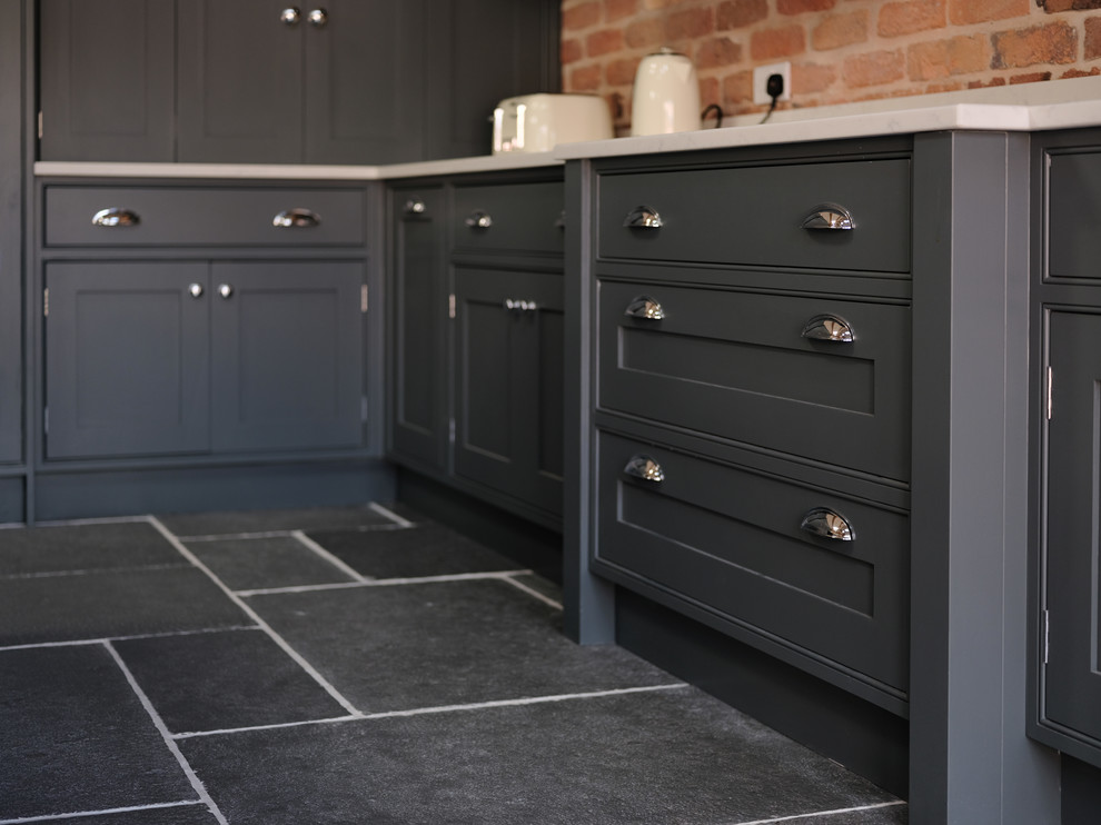 Inspiration for a traditional kitchen in Cheshire with quartz worktops, slate flooring, an island and grey floors.