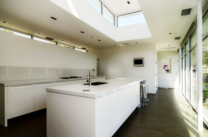 Mid-sized minimalist kitchen photo in Dallas with flat-panel cabinets, white cabinets, quartz countertops, white backsplash and an island