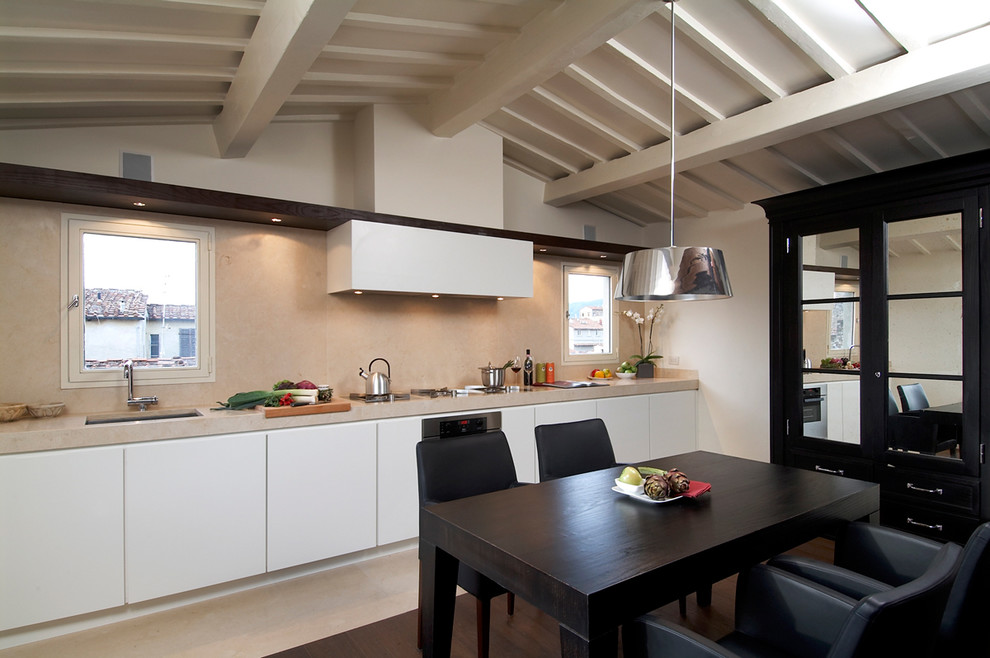 Example of a large trendy single-wall eat-in kitchen design in Florence with an undermount sink, flat-panel cabinets, white cabinets and stainless steel appliances