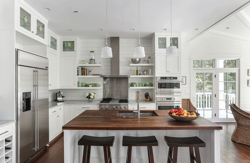Example of a beach style l-shaped eat-in kitchen design in Charleston with a single-bowl sink, shaker cabinets, white cabinets, wood countertops and stainless steel appliances