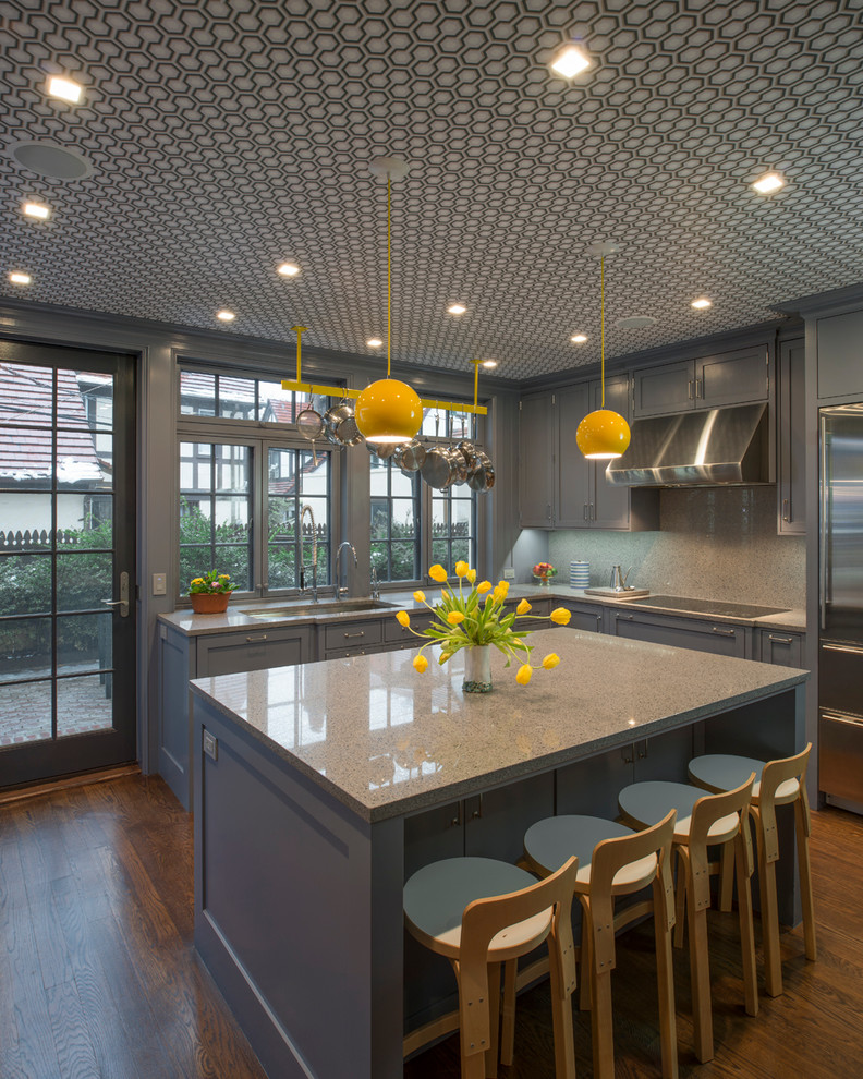 Example of a large trendy u-shaped medium tone wood floor kitchen design in New York with recessed-panel cabinets, quartz countertops, an island, an undermount sink and green cabinets