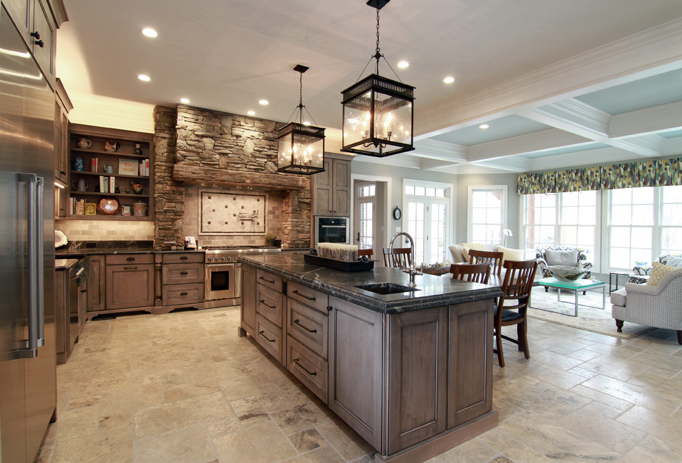 Inspiration for a huge rustic l-shaped ceramic tile open concept kitchen remodel in St Louis with a farmhouse sink, shaker cabinets, distressed cabinets, granite countertops, beige backsplash, stone tile backsplash, stainless steel appliances and two islands