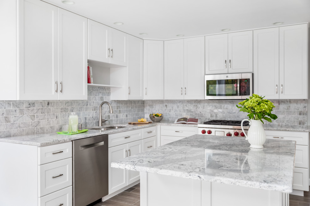 Large beach style l-shaped ceramic tile and gray floor eat-in kitchen photo in Philadelphia with a single-bowl sink, shaker cabinets, white cabinets, quartzite countertops, gray backsplash, marble backsplash, paneled appliances, an island and gray countertops