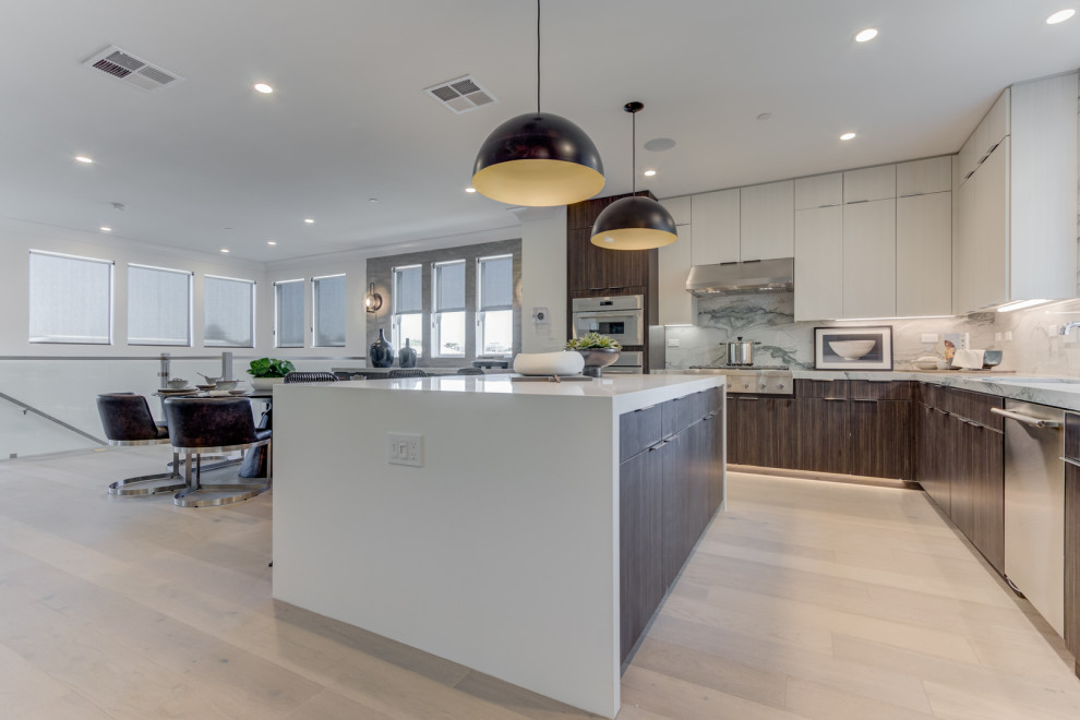 Inspiration for a l-shaped open concept kitchen remodel in San Francisco with shaker cabinets, stainless steel appliances, an island and an undermount sink
