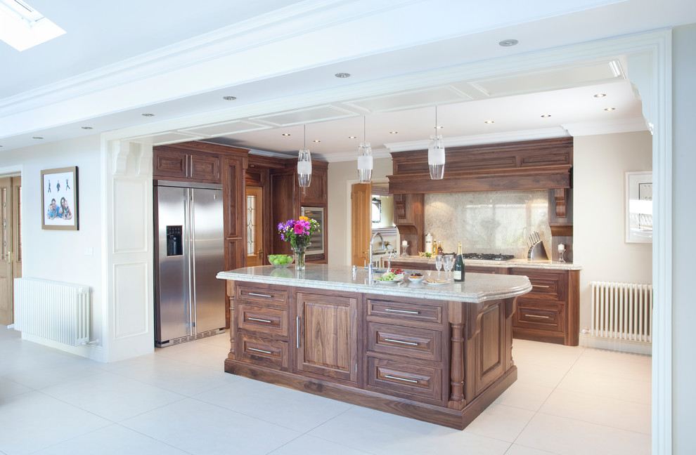 This is an example of a medium sized classic u-shaped kitchen/diner in Other with a submerged sink, raised-panel cabinets, dark wood cabinets, granite worktops, beige splashback, stone slab splashback, stainless steel appliances, porcelain flooring and an island.