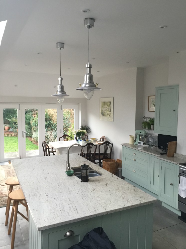 Medium sized country kitchen/diner in Oxfordshire with a submerged sink, shaker cabinets, green cabinets, ceramic flooring and an island.