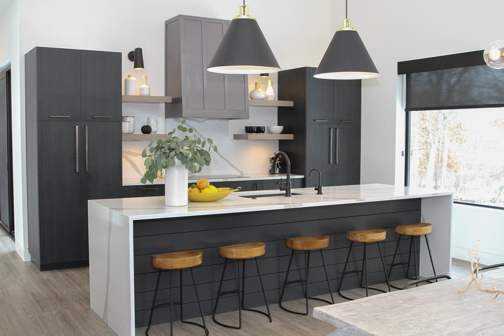 Contemporary kitchen/diner in Grand Rapids with a submerged sink, flat-panel cabinets, grey cabinets, white splashback, an island, beige floors and white worktops.