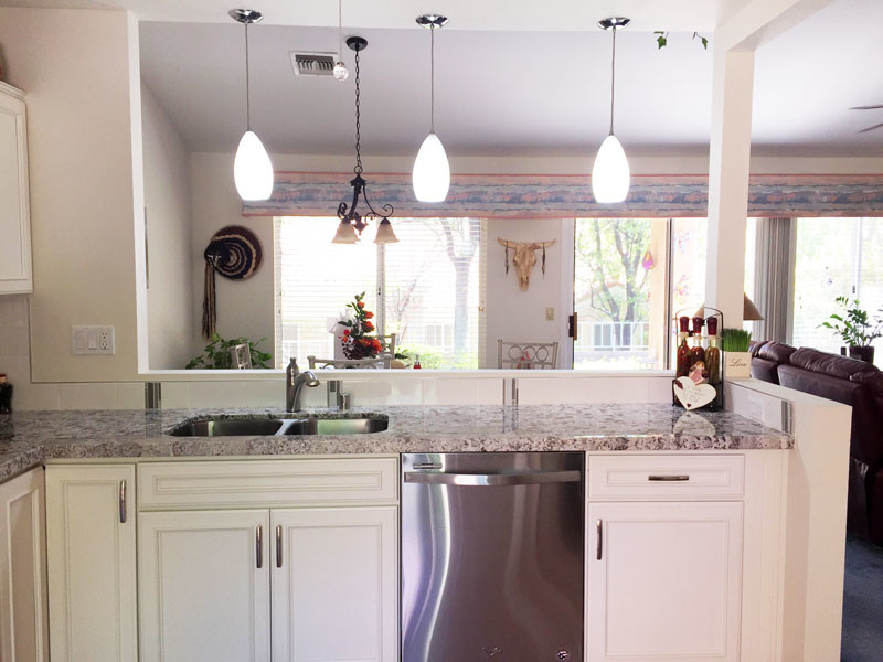 Small transitional l-shaped porcelain tile and pink floor kitchen pantry photo in Las Vegas with a double-bowl sink, beaded inset cabinets, white cabinets, quartz countertops, white backsplash, porcelain backsplash, stainless steel appliances and no island
