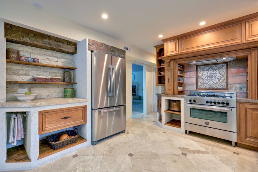 Mid-sized tuscan u-shaped eat-in kitchen photo in Atlanta with medium tone wood cabinets, stainless steel appliances and no island