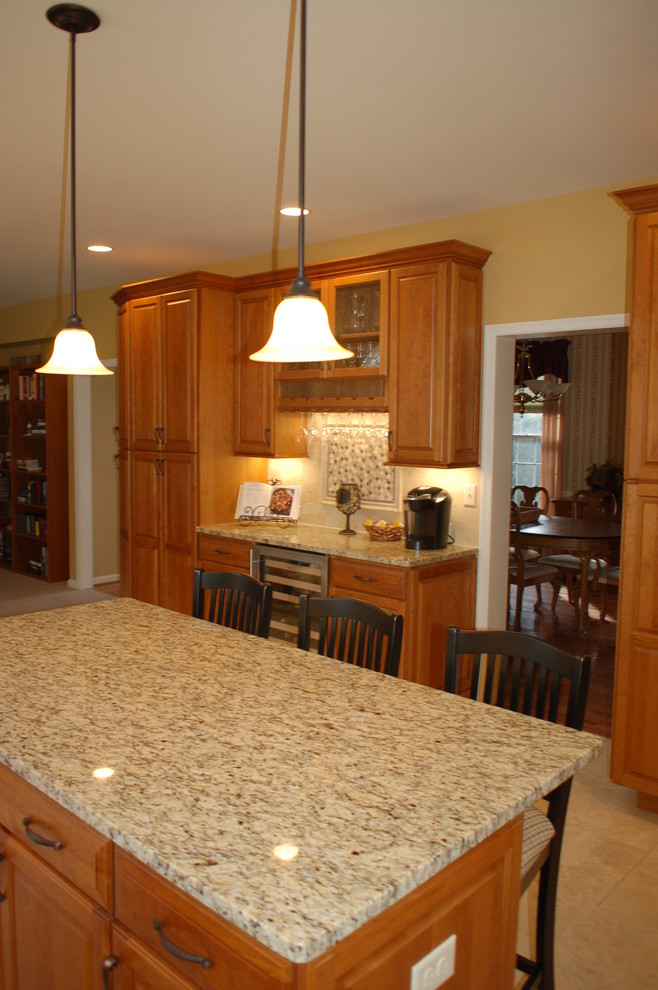 Photo of a classic u-shaped kitchen in Philadelphia with a submerged sink, recessed-panel cabinets, medium wood cabinets, granite worktops and stainless steel appliances.
