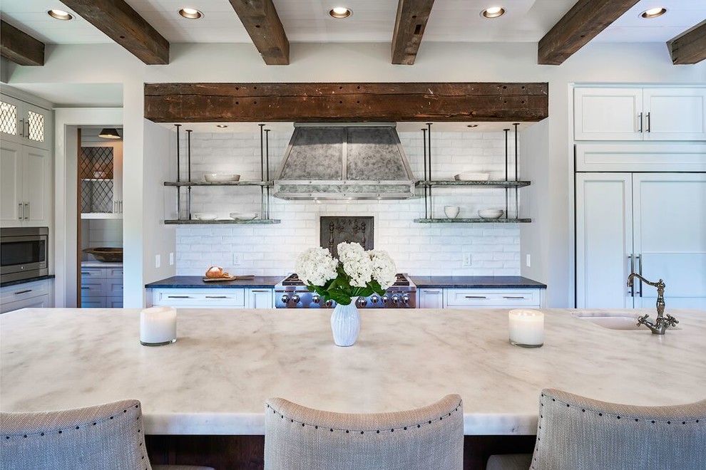 Inspiration for a farmhouse kitchen remodel in Atlanta with an undermount sink, recessed-panel cabinets, blue cabinets, marble countertops, white backsplash, stainless steel appliances and an island