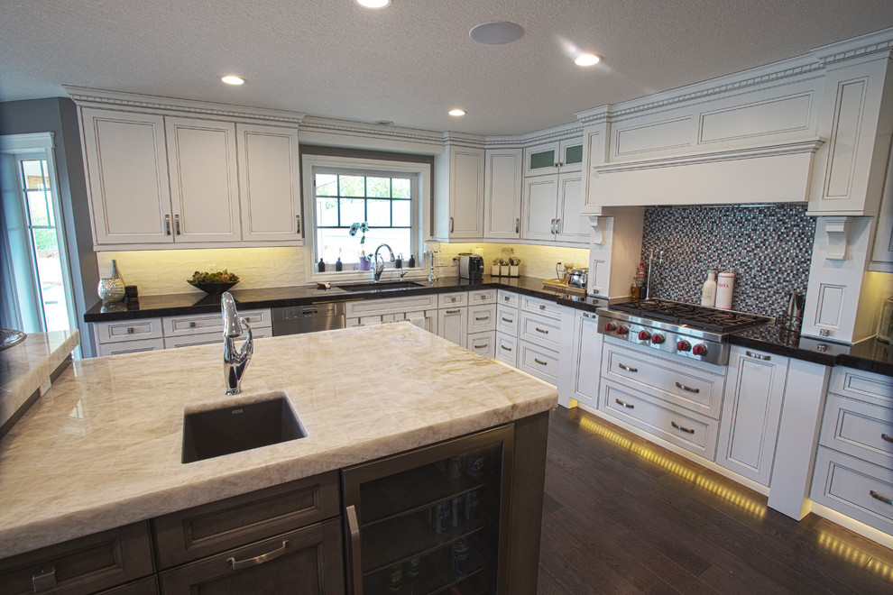 Example of a large arts and crafts u-shaped open concept kitchen design in Edmonton with an undermount sink, shaker cabinets, dark wood cabinets, granite countertops, white backsplash, subway tile backsplash, stainless steel appliances and an island