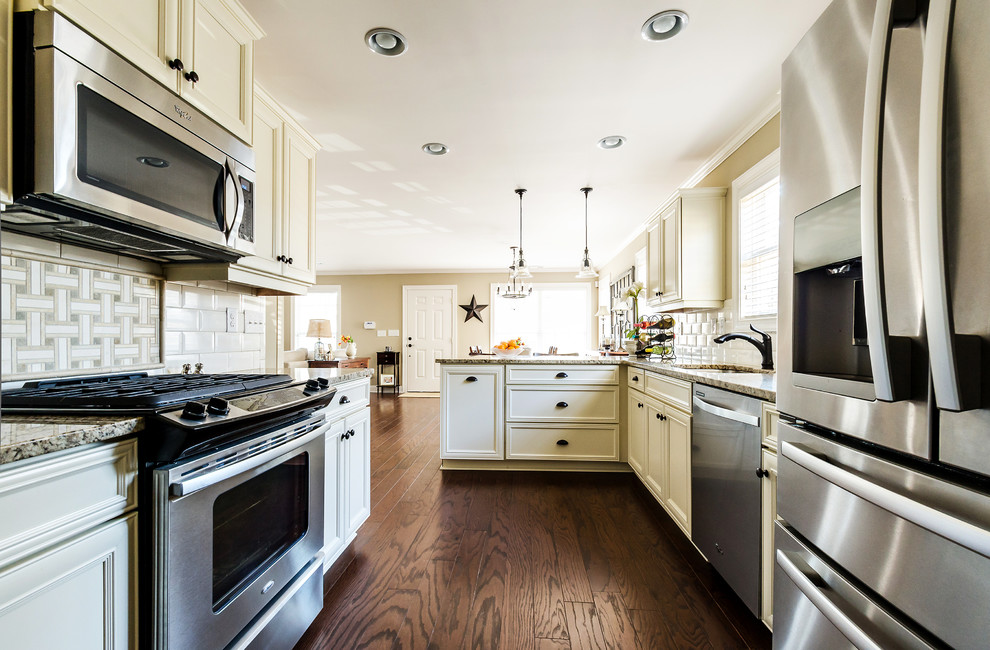 Photo of a classic kitchen in Atlanta with stainless steel appliances and metro tiled splashback.