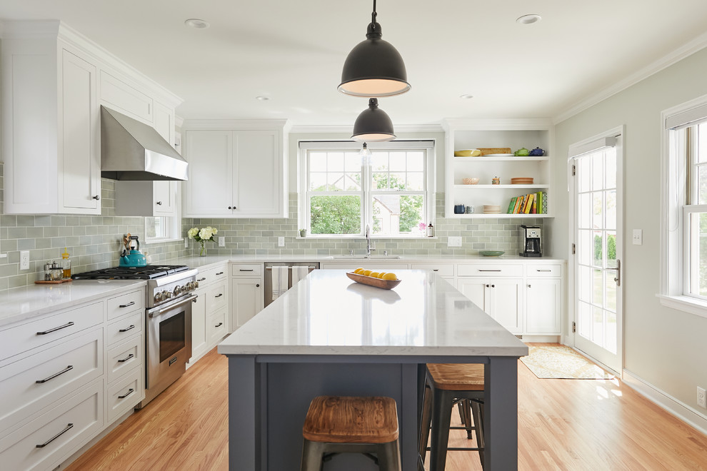 Design ideas for a classic enclosed kitchen in Minneapolis with a double-bowl sink, shaker cabinets, white cabinets, engineered stone countertops, green splashback, porcelain splashback, stainless steel appliances, medium hardwood flooring, an island and grey worktops.