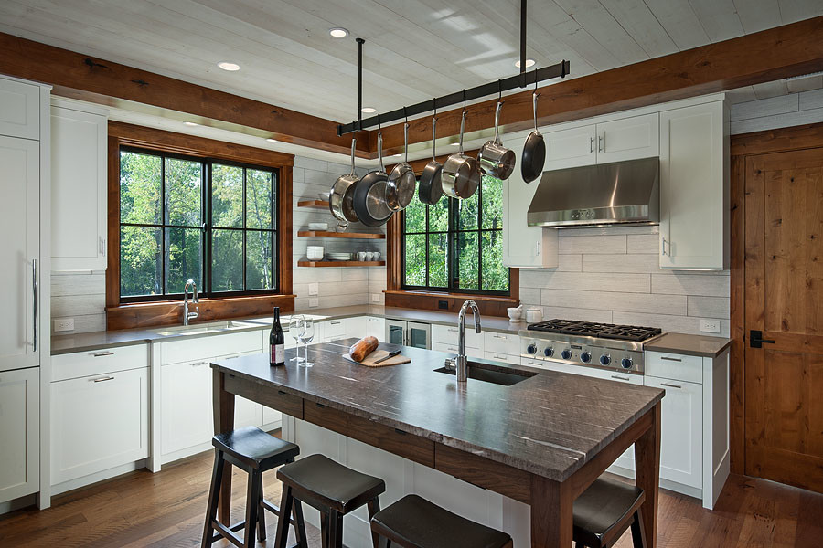 Inspiration for a mid-sized transitional u-shaped medium tone wood floor and brown floor open concept kitchen remodel in Other with an undermount sink, shaker cabinets, white cabinets, quartz countertops, white backsplash, ceramic backsplash, paneled appliances, two islands and brown countertops