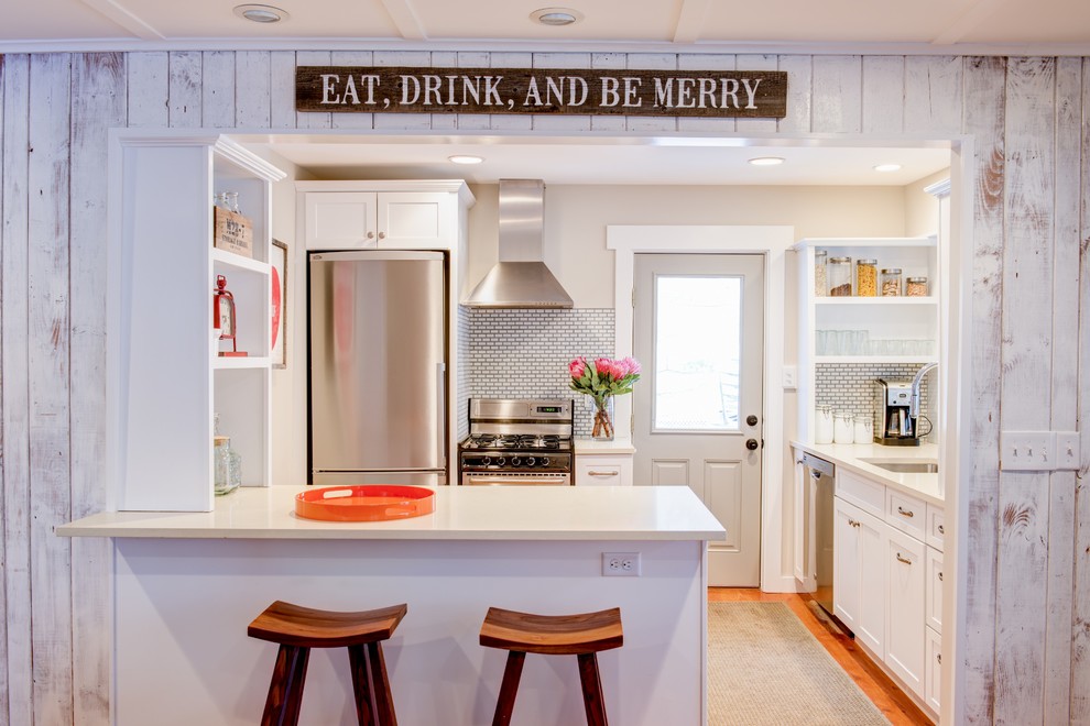Example of a small beach style medium tone wood floor eat-in kitchen design in Other with an undermount sink, open cabinets, white cabinets, subway tile backsplash, stainless steel appliances and a peninsula