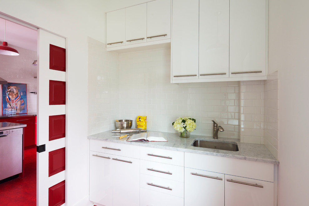 Small contemporary single-wall kitchen pantry in Calgary with a submerged sink, flat-panel cabinets, white cabinets, marble worktops, white splashback, metro tiled splashback and no island.