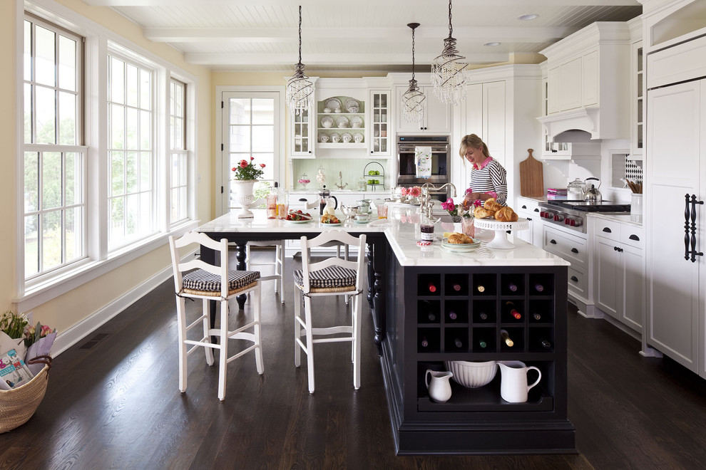Mid-sized elegant l-shaped dark wood floor open concept kitchen photo in Minneapolis with white cabinets, an undermount sink, shaker cabinets, marble countertops, white backsplash, ceramic backsplash, stainless steel appliances and an island