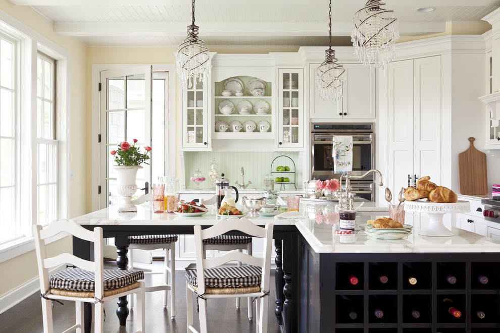 Open concept kitchen - mid-sized traditional l-shaped dark wood floor open concept kitchen idea in Minneapolis with recessed-panel cabinets, white cabinets, an undermount sink, marble countertops, green backsplash, stainless steel appliances and an island