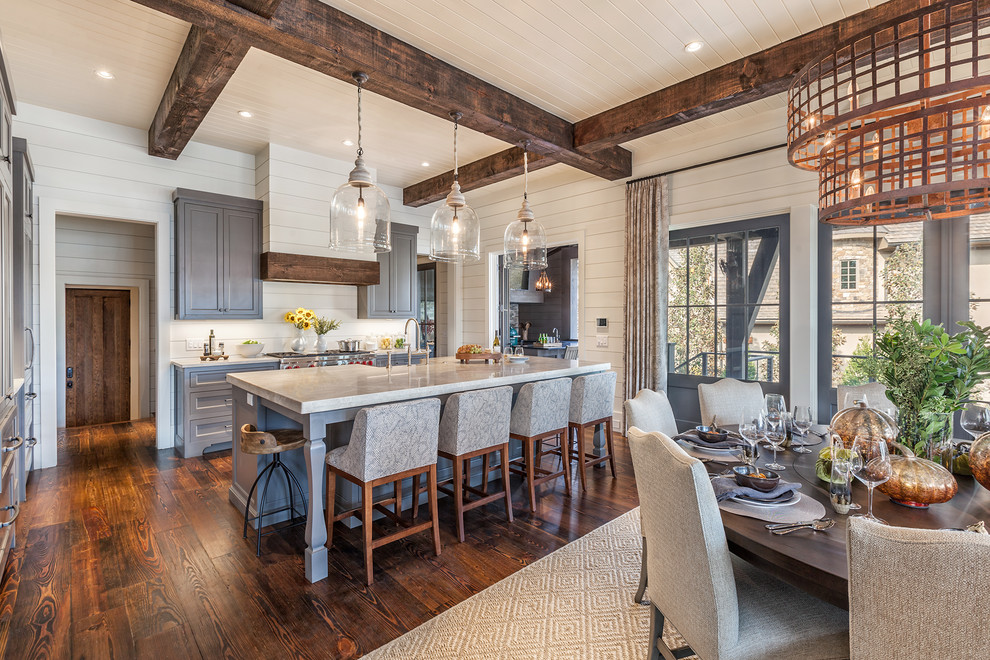 Example of a large farmhouse galley dark wood floor open concept kitchen design in Other with a farmhouse sink, shaker cabinets, gray cabinets, marble countertops, white backsplash, wood backsplash, stainless steel appliances and an island