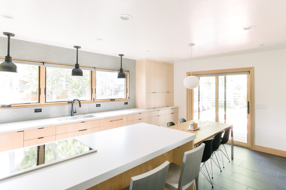Design ideas for a large traditional galley kitchen/diner in Salt Lake City with a single-bowl sink, flat-panel cabinets, light wood cabinets, quartz worktops, grey splashback, stainless steel appliances, ceramic flooring, an island, grey floors and white worktops.