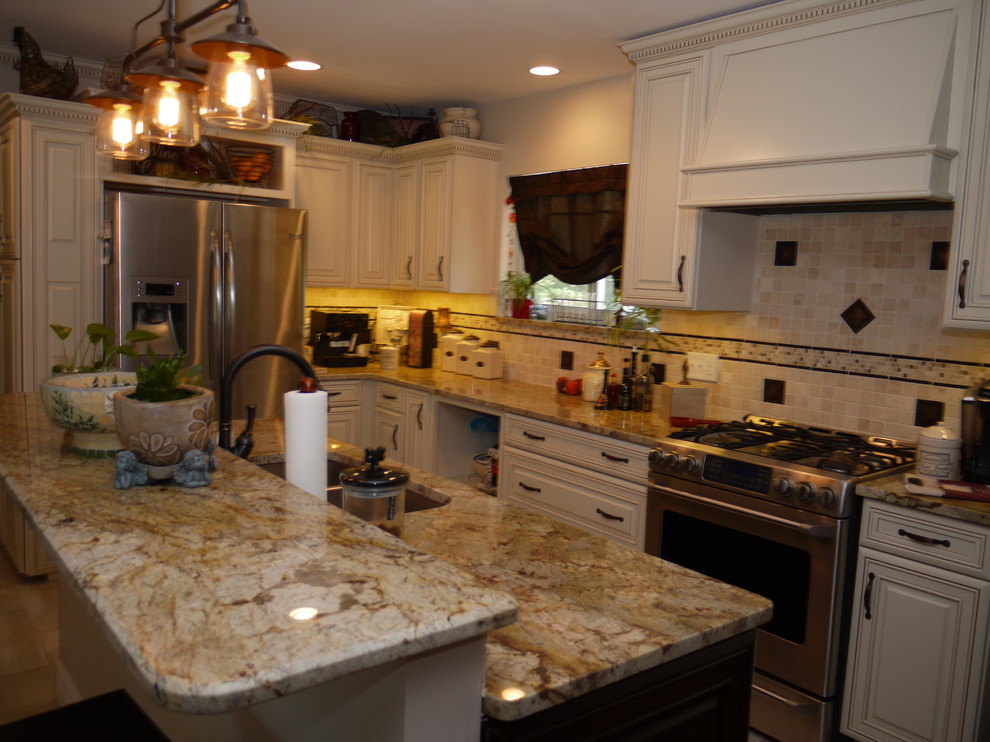 Example of a classic ceramic tile kitchen design in St Louis with a double-bowl sink, granite countertops, stainless steel appliances and an island
