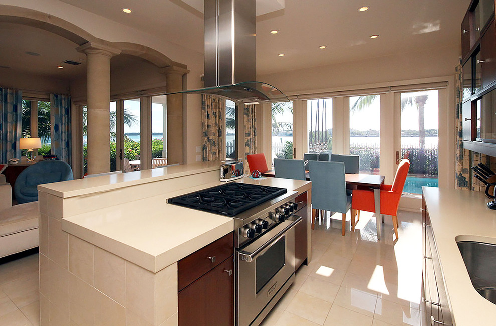 Mid-sized trendy l-shaped marble floor and beige floor eat-in kitchen photo in Miami with an undermount sink, flat-panel cabinets, dark wood cabinets, concrete countertops, metallic backsplash, metal backsplash, stainless steel appliances and an island